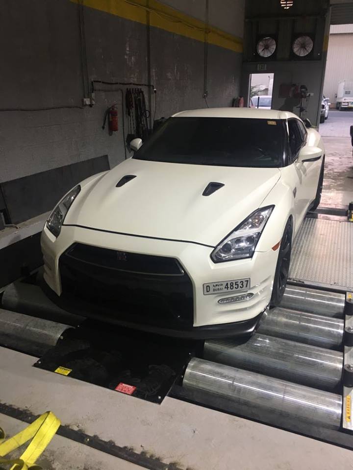 White Nissan GT-R front view strapped on Dynocom AWD 15,000 GDFX dynamometer in Dubai performance shop