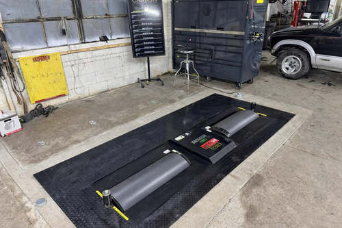 Dynocom 15,000 Series pit-mount chassis dynamometer flush installed in shop floor with diamond plate surround