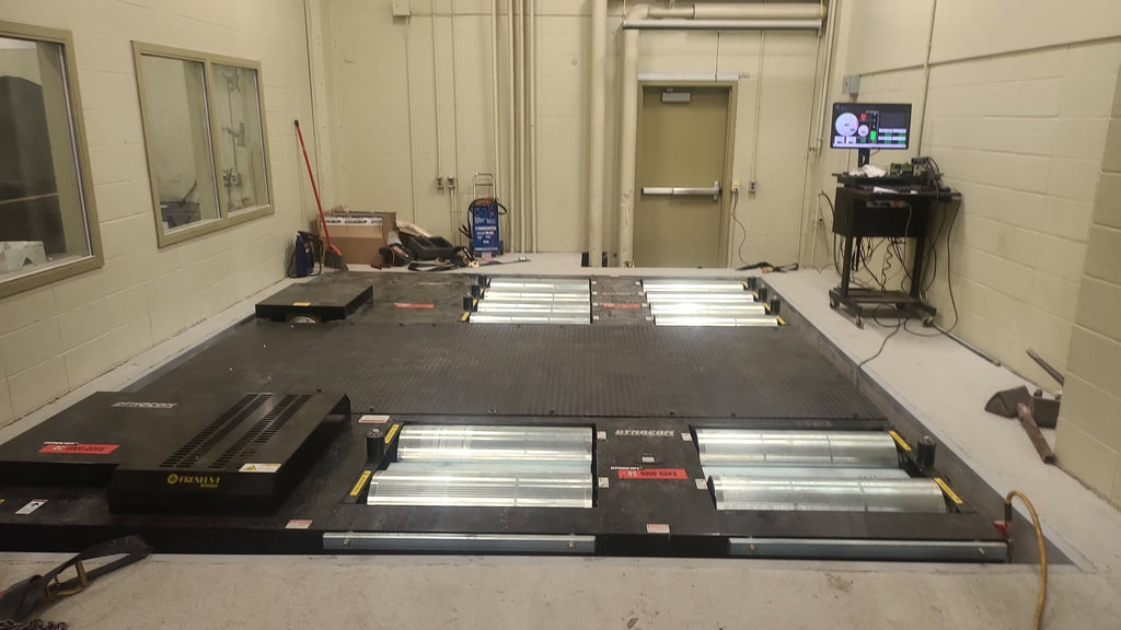 Dynocom AWD-5000GDX pit-mount AWD dynamometer installed in dyno room with Quantum software monitor