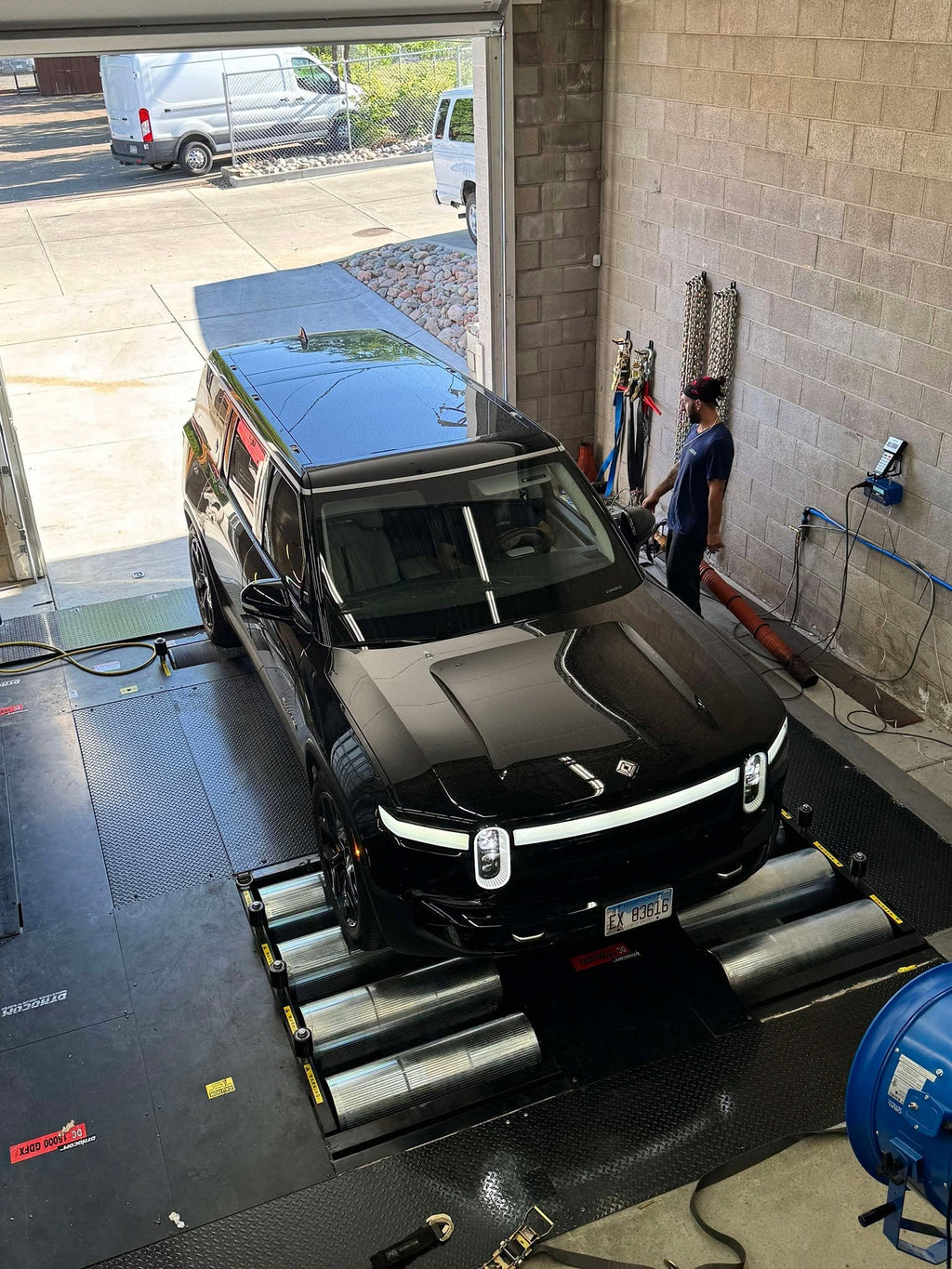Black Rivian R1S electric SUV overhead view on Dynocom AWD 15,000 GDFX dynamometer rollers