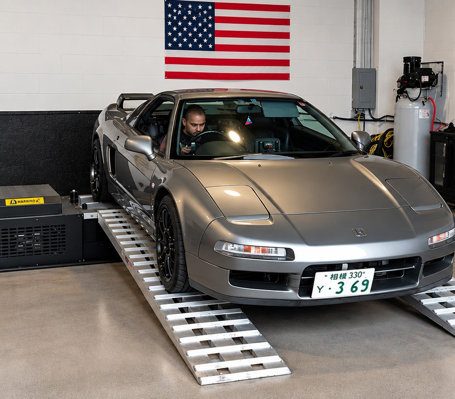 Silver Honda NSX on Dynocom 6000 Series dyno in clean performance shop with American flag