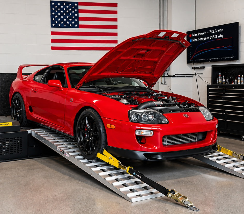Red Toyota Supra making 742 WHP on Dynocom dyno with power curve displayed on monitor