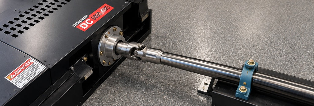 Close-up of Dynocom DC 6000 AWD driveshaft and universal joint linkage connection between front and rear dyno units