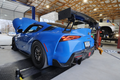 Blue Toyota GR Supra strapped on Dynocom 15000 Series chassis dynamometer in performance shop