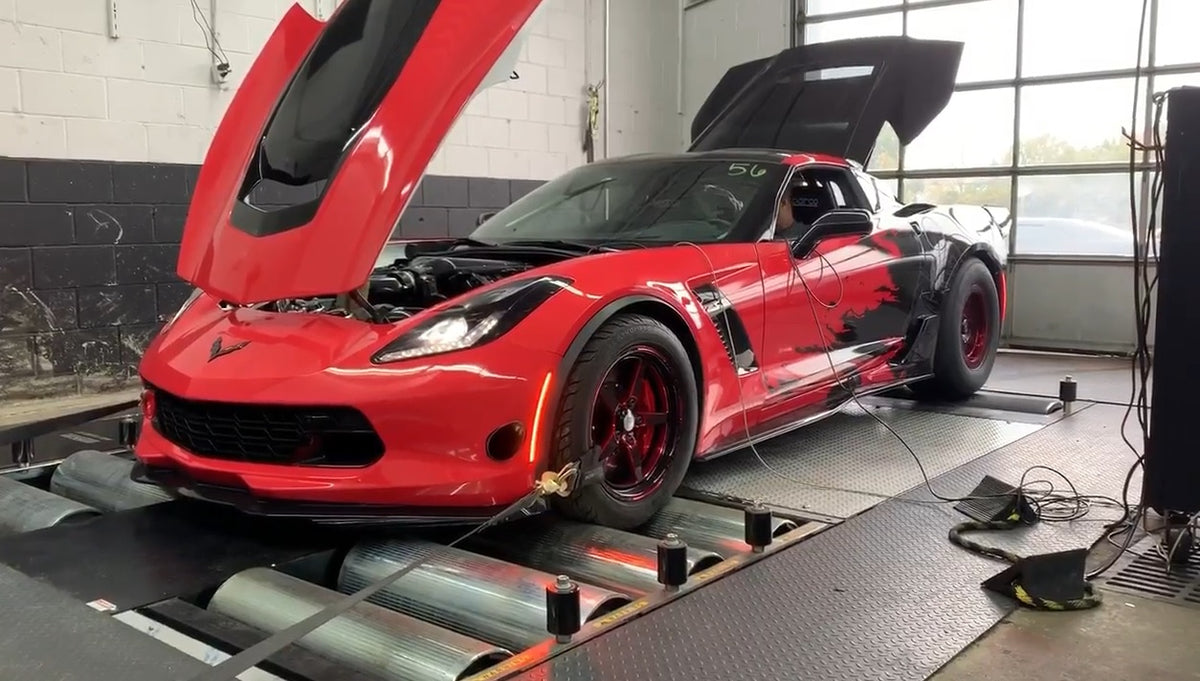 Red Chevrolet Corvette Z06 with hood open on Dynocom AWD 15,000 GDFX chassis dynamometer