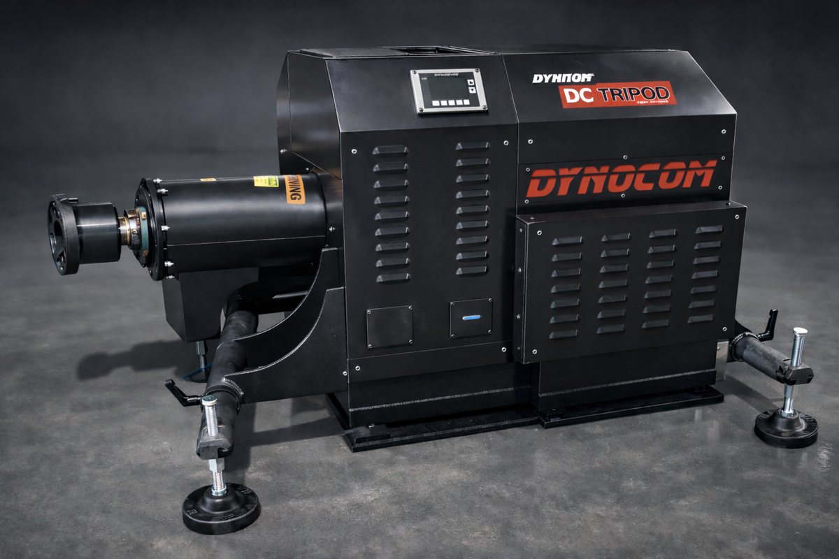 Dynocom DC Tripod 7500 Series hub dynamometer unit in black with red branding on dark studio background